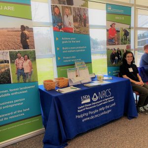 Emily Palmer staffing the NRCS booth at the Delmarva Soil Summit.